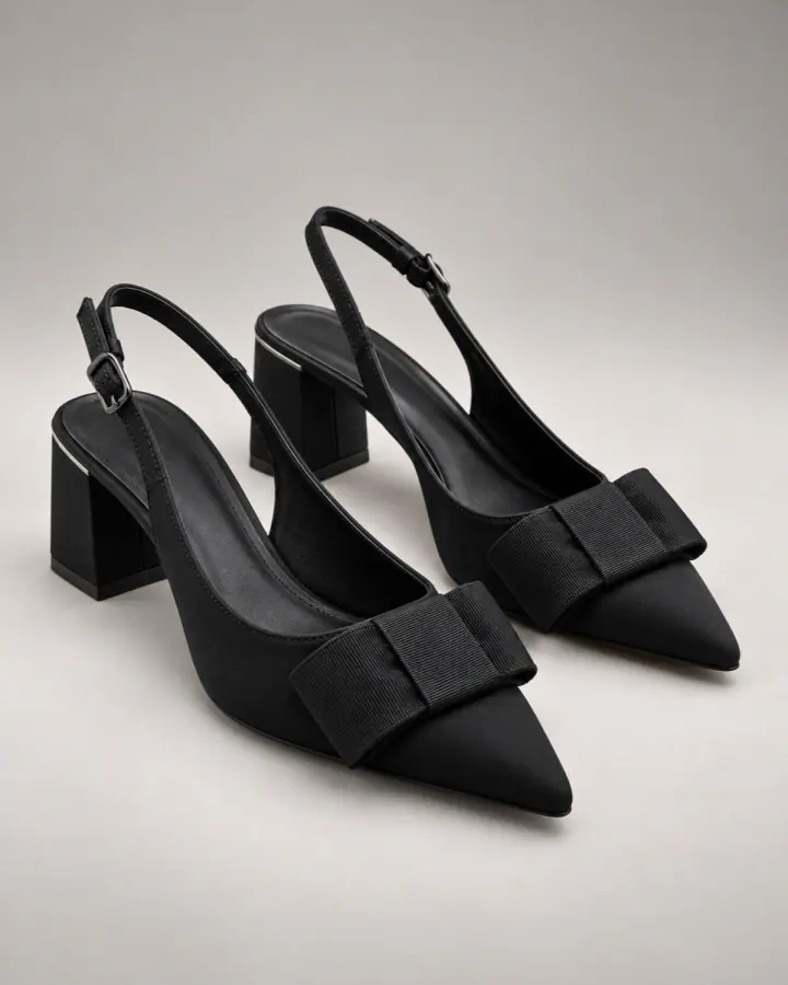 Black bow slingback heels in a polished studio product photo